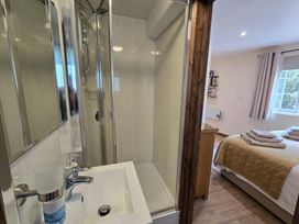 A bathroom with a shower and sink at Ty Barddu in Cwmorgan near Newcastle Emlyn