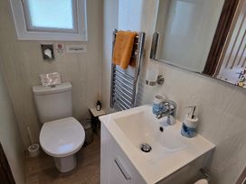 A bathroom with a toilet and sink at Ty Barddu, Cwmorgan near Newcastle Emlyn