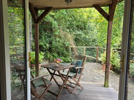 An outdoor seating area with table and chairs at Ty Barddu Cwmorgan near Newcastle Emlyn