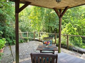 An outdoor seating area with a table and chairs at Ty Barddu Cwmorgan near Newcastle Emlyn