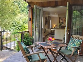 A patio with a table and chairs at Ty Barddu in Cwmorgan near Newcastle Emlyn