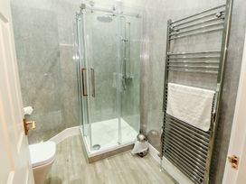 A bathroom with a shower and towel rail at Silver How in Ambleside