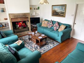 A living room with a sofa and fireplace at Two Towers Cottage in Montacute