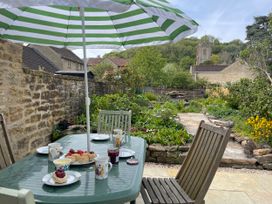 A garden with table and food items at Two Towers Cottage Montacute