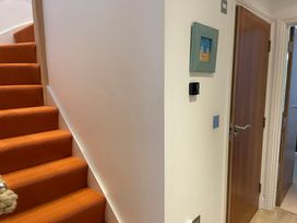 A hallway with stairs and a door at Hamnavoe in Stoke Fleming