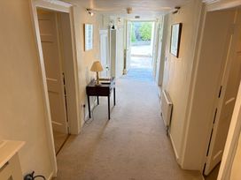 A hallway with a table and lamp at Malabar House in Lyme Regis