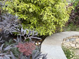 A garden with shrubs and a stone pathway at Malabar House Lyme Regis