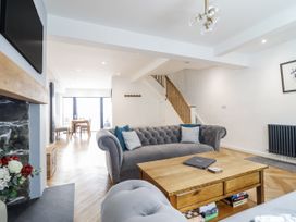 A living room with a sofa and coffee table at Neptune Cottage in Conwy