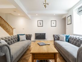 A living room with sofas and a coffee table at Neptune Cottage in Conwy