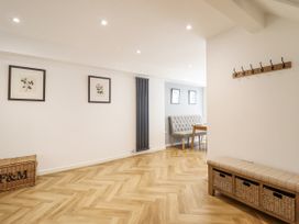 A dining room with a table and chairs at Neptune Cottage in Conwy