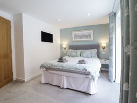A bedroom with a bed and bedside table at Neptune Cottage in Conwy