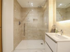 A bathroom with a shower and a sink at Neptune Cottage in Conwy
