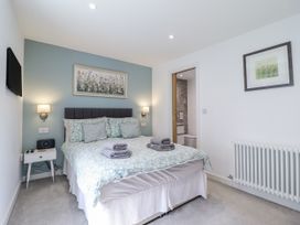 A bedroom with a bed and a bedside table at Neptune Cottage in Conwy