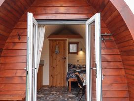 A pod with a bed and table at Pod 2 in Beauly