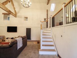 A living room with a sofa and television at Godre'r Gyrn, Plas Moelfre Hall Barns, Oswestry