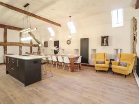 A kitchen with a dining table and chairs at Godre'r Gyrn, Plas Moelfre Hall Barns, Oswestry