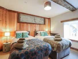 A bedroom with two beds and a window at Godre'r Gyrn, Plas Moelfre Hall Barns, Oswestry