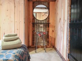 A hallway with a mirror and shelf at Godre'r Gyrn, Plas Moelfre Hall Barns, Oswestry