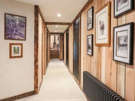 A hallway with framed pictures and a radiator at Godre'r Gyrn, Plas Moelfre Hall Barns in Oswestry