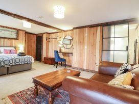 A living room with a sofa table and bed at Godre'r Gyrn, Plas Moelfre Hall Barns Oswestry