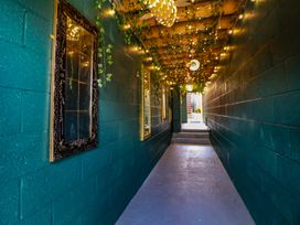 A hallway with mirrors and decorative lights at The Funky Flat in Holywell