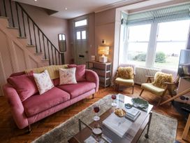 A living room with a sofa and armchairs at Astondene, East Cliff, Southwold