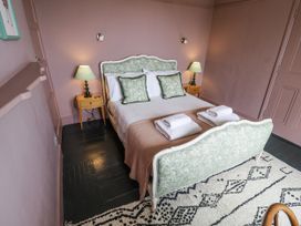 A bedroom with a bed and bedside tables at Astondene, East Cliff Southwold