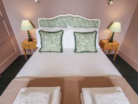 A bedroom with a bed and bedside tables at Astondene, East Cliff in Southwold
