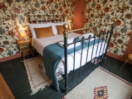 A bedroom with a bed and bedside table at Astondene, East Cliff, Southwold