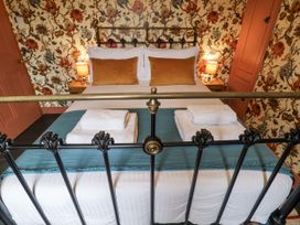 A bedroom with a bed and lamps at Astondene, East Cliff in Southwold