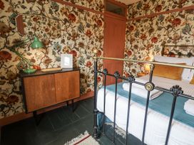 A bedroom with a bed and decorative items at Astondene, East Cliff, Southwold
