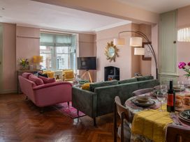 A living room with a sofa and dining area at Astondene, East Cliff Southwold