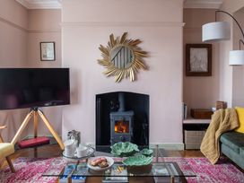 A living room with a fireplace and television at Astondene, East Cliff, Southwold