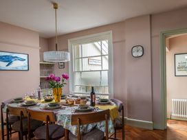 A dining room with a table set for a meal at Astondene, East Cliff, Southwold