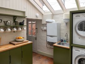 A kitchen with a sink and washing machine at Astondene, East Cliff, Southwold