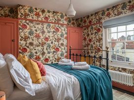 A bedroom with a bed and window at Astondene, East Cliff in Southwold