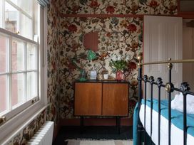 A bedroom with a bed and a nightstand at Astondene, East Cliff in Southwold
