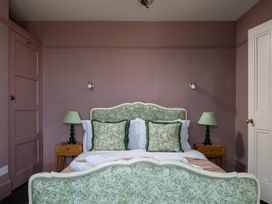 A bedroom with a bed and lamps at Astondene, East Cliff in Southwold