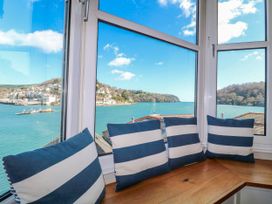 A window nook with cushions and a view of the water at Harbourside in Dartmouth