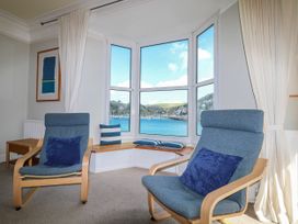 A living room with armchairs and a view of the harbor at Harbourside in Dartmouth