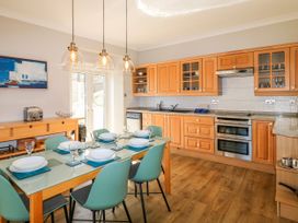 A kitchen with dining table and chairs at Harbourside in Dartmouth