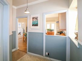 A hallway with a painting and door leading to the kitchen at Harbourside Dartmouth