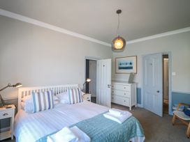 A bedroom with a bed and dresser at Harbourside in Dartmouth