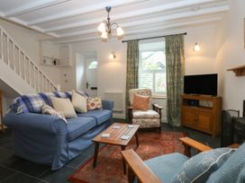 A living room with a sofa and armchair at Chandos in Dolwyddelan