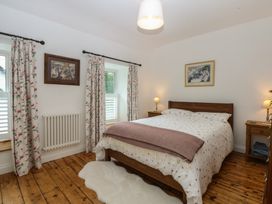 A bedroom with a bed and bedside table at Chandos in Dolwyddelan