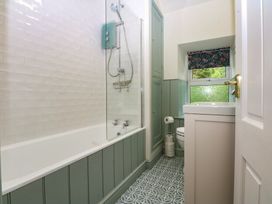A bathroom with a shower and bath tub at Chandos in Dolwyddelan