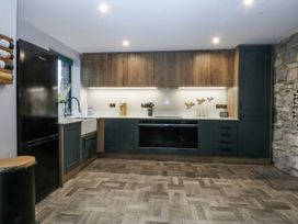 A kitchen with cabinets and appliances at Windyridge, Gwaenysgor, near Prestatyn