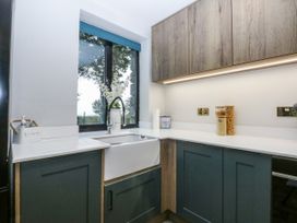 A kitchen with a sink and cabinets at Windyridge Gwaenysgor near Prestatyn