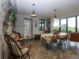 A dining room with a table and chairs at Windyridge, Gwaenysgor, near Prestatyn