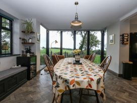 A dining room with a table and chairs at Windyridge in Gwaenysgor, near Prestatyn